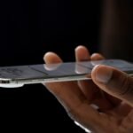 A hand holding the iPhone Air, which is 5.6 millimeters thin, meaningfully thinner than the 8.2-millimeter-thin iPhone 17 Pro.