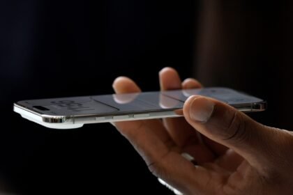 A hand holding the iPhone Air, which is 5.6 millimeters thin, meaningfully thinner than the 8.2-millimeter-thin iPhone 17 Pro.