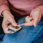 Type 2 diabetes, woman pricking her finger