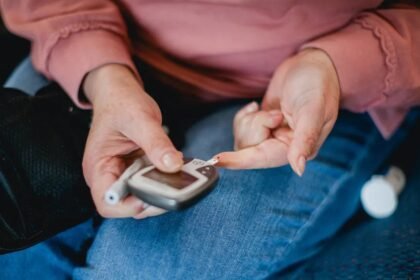 Type 2 diabetes, woman pricking her finger